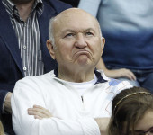 Moscow mayor Luzhkov reacts as he watches the play of compatriot Petrova against Spain's Navarro during their Fed Cup tennis match in Moscow